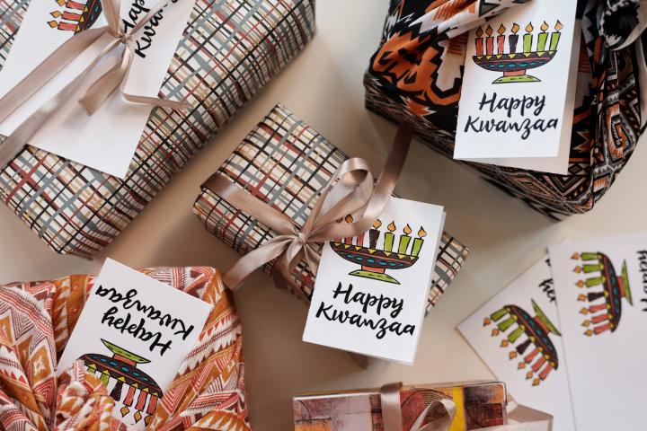 Kwanzaa gifts wrapped in happy kwanzaa paper