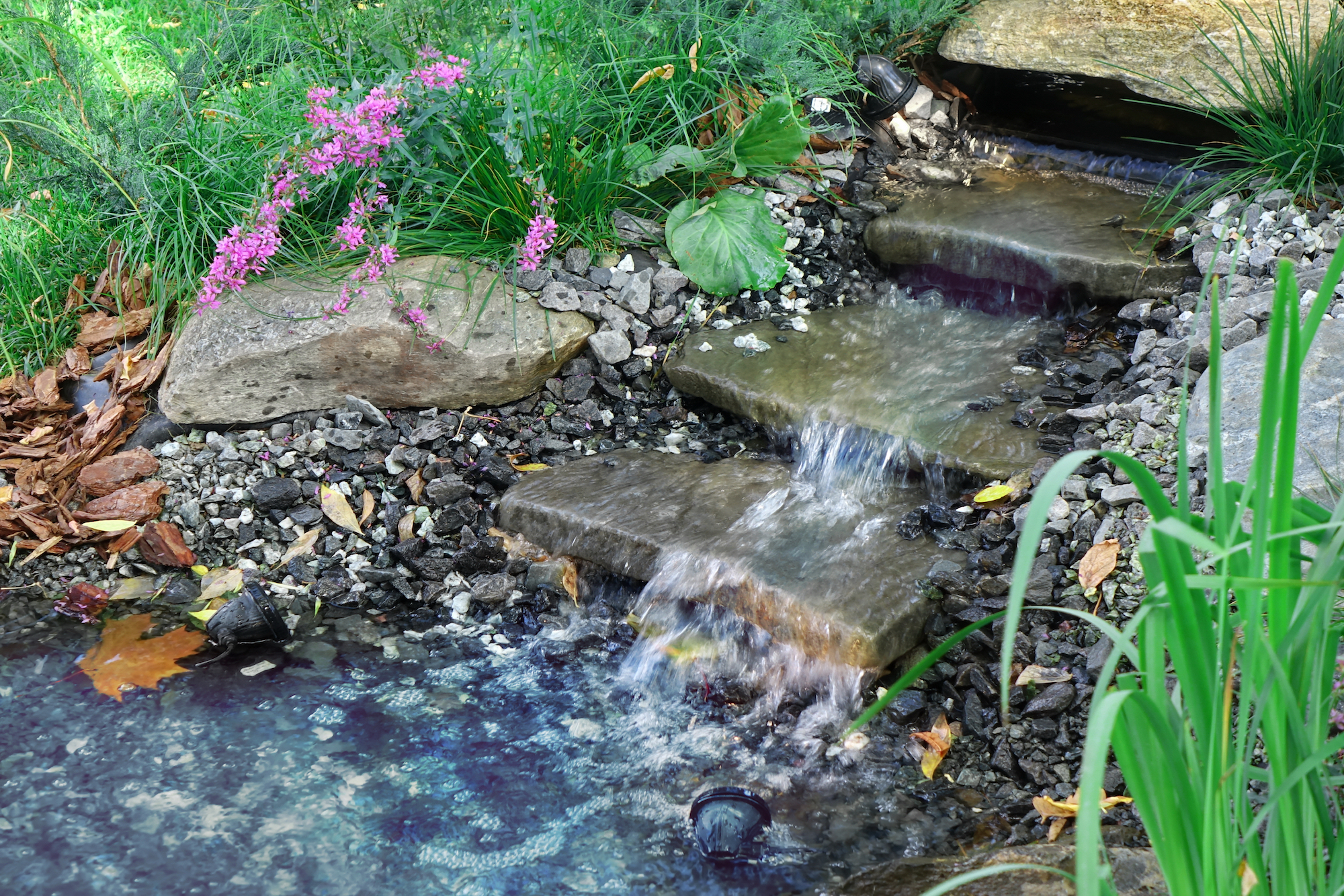 Garden water feature with water running down stairs